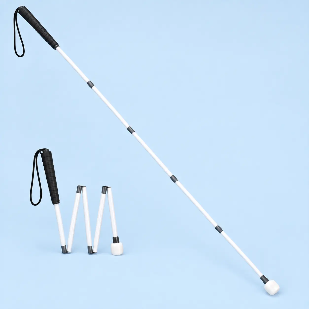 A long folding white mobility cane with a dark grip and roller-marshmallow tip, shown open and folded