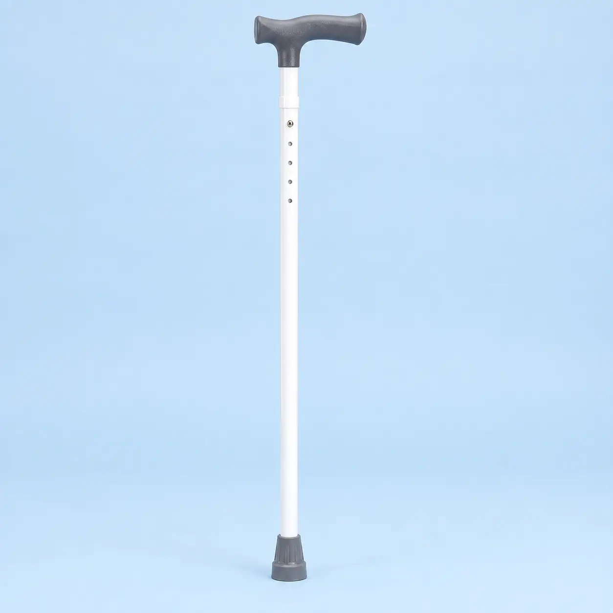 An upright adjustable white support cane with a dark ergonomic handle and rubber ferrule
