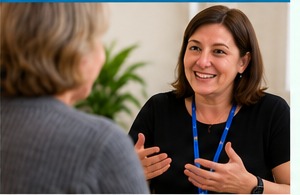 Person explaining practical support needs during a conversation